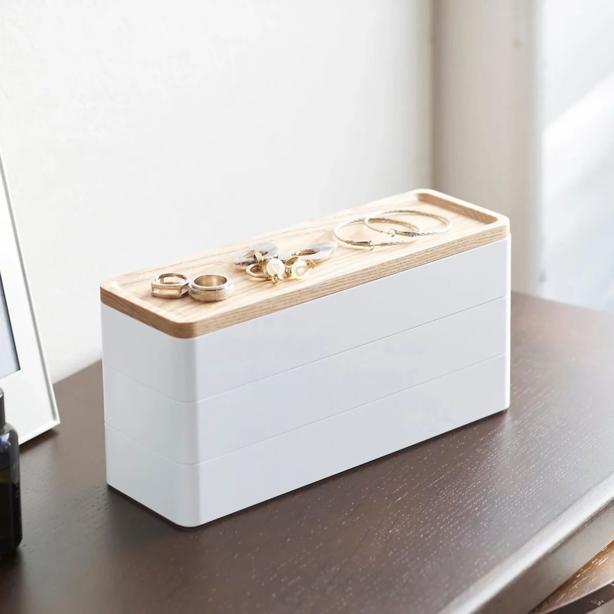Yamazaki RIN 3-Tier Narrow Jewelry Box in White, on the dresser with rings on the lid