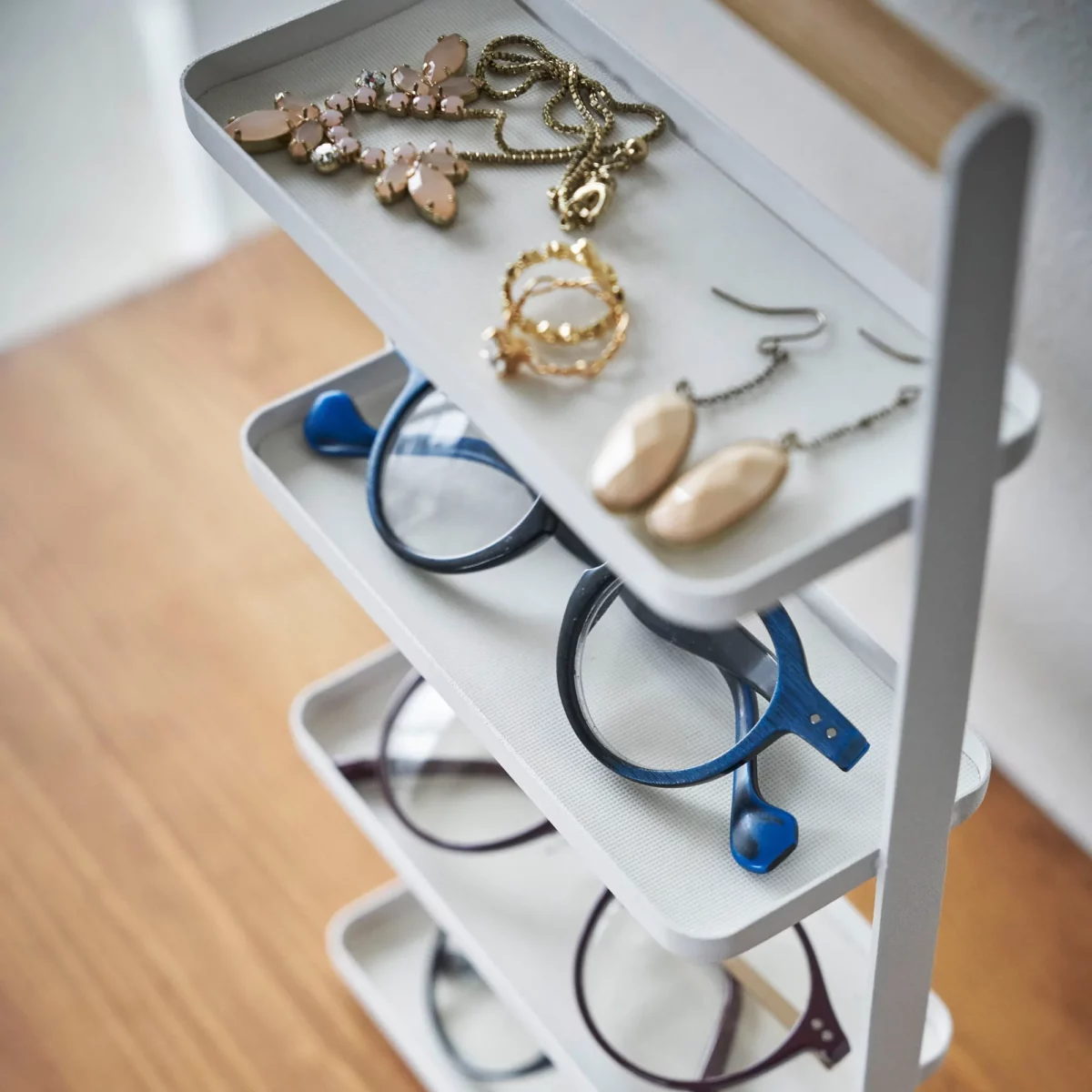 Yamazaki TOSCA 4-Tier Jewelry Stand in White; glasses and jewelry on the lower shelves