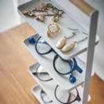 Yamazaki TOSCA 4-Tier Jewelry Stand in White; glasses and jewelry on the lower shelves