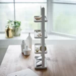 Yamazaki TOSCA 4-Tier Jewelry Stand in White, viewed from the front on the table in front of the window