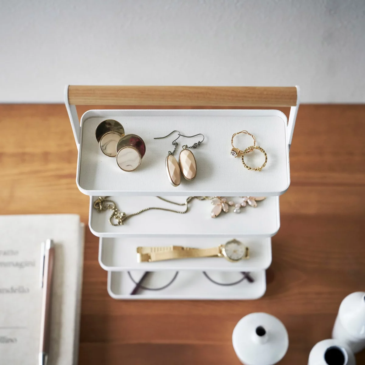 Yamazaki TOSCA 4-Tier Jewelry Stand in White, shown from above with earrings, a necklace, and a watch