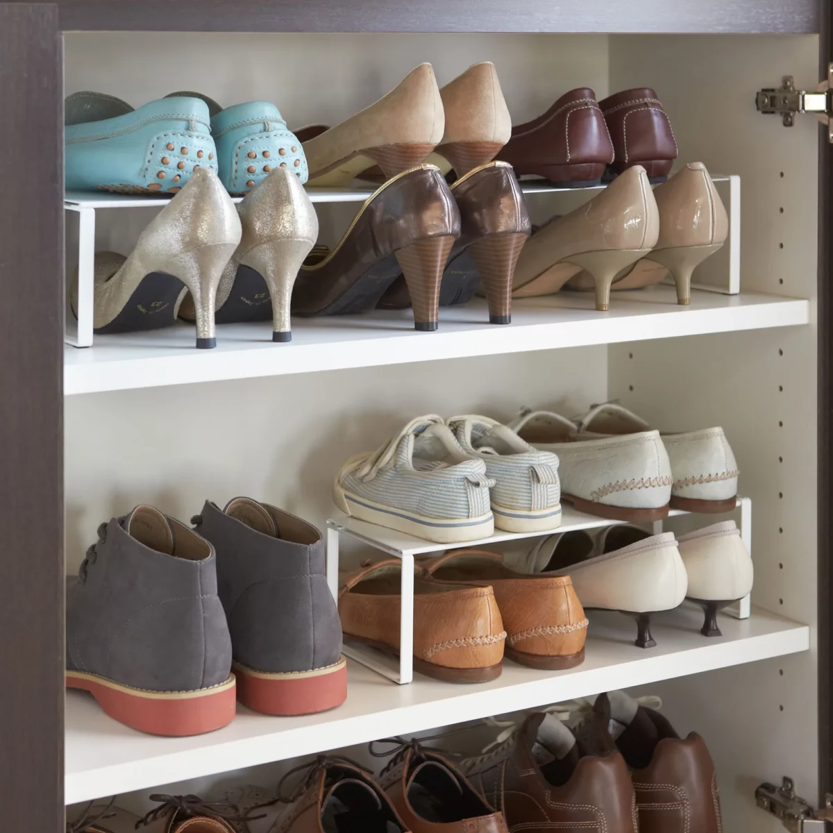 Yamazaki FRAME Shoe Rack for the Shoe Cabinet in White, with sneakers stacked on top of boots inside the shoe cabinet