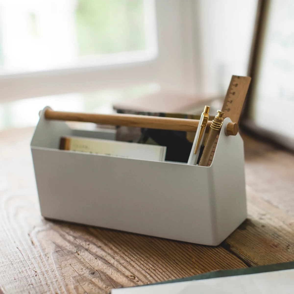 Yamazaki TOSCA Wide Pen Holder in White, on the table by the window with books
