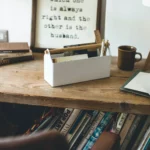 Yamazaki TOSCA Wide Pencil Holder in White, on a wooden desk next to a cup