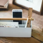 Yamazaki TOSCA Wide Pen Holder in White, with a smartphone standing upright in the front compartment