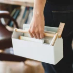 Yamazaki TOSCA Wide Pen Holder in White; a hand is holding the pen holder by its wooden grip