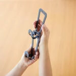 Yamazaki CHAIN S Bag Holder for Hanging, Black; hands connecting two links of the chain