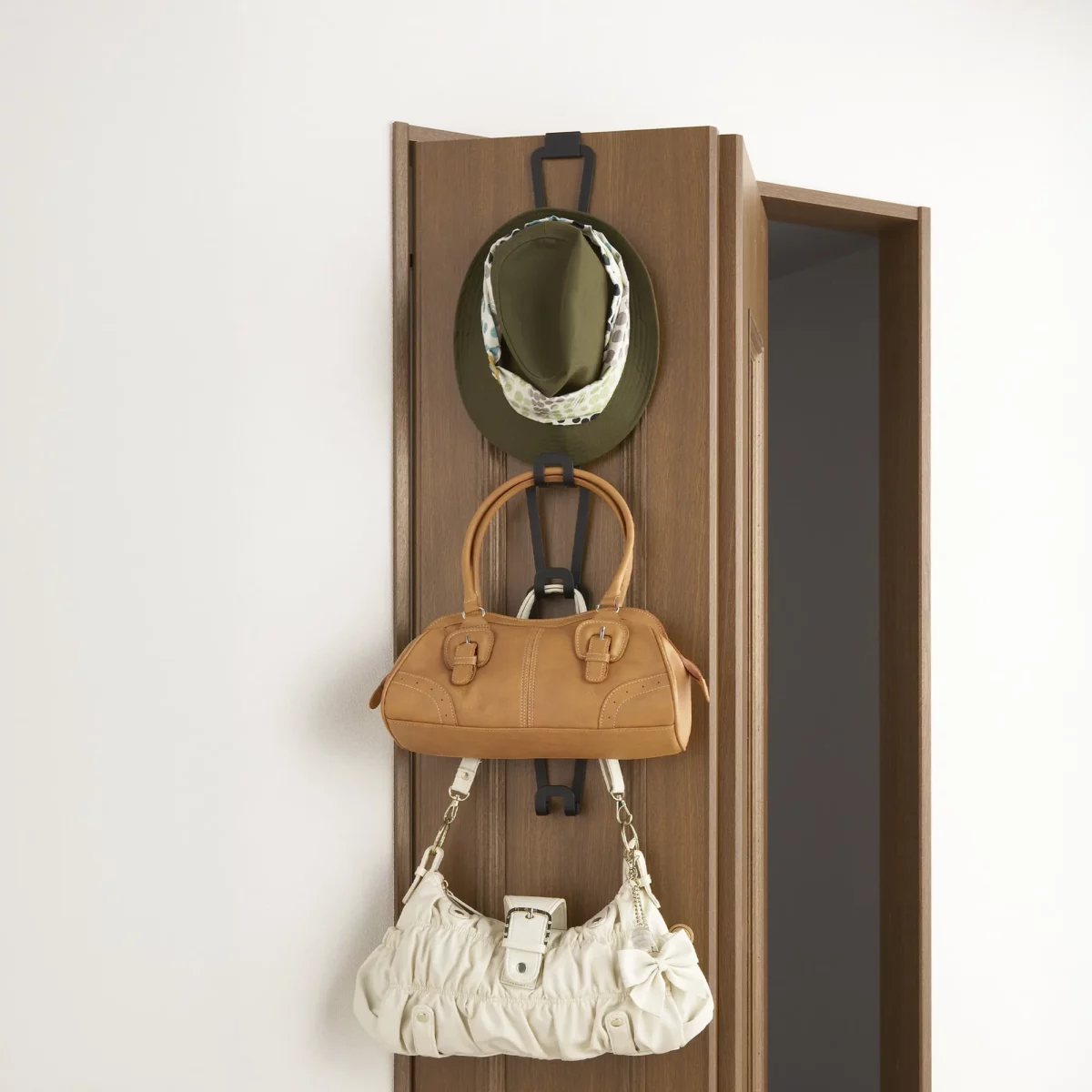 Yamazaki CHAIN S Bag Holder in Black, for hanging on a wooden door, with a hat and three bags
