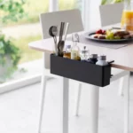 Yamazaki TOWER Narrow Table Clamp Basket in Black, clamped to the dining table with cutlery and spices