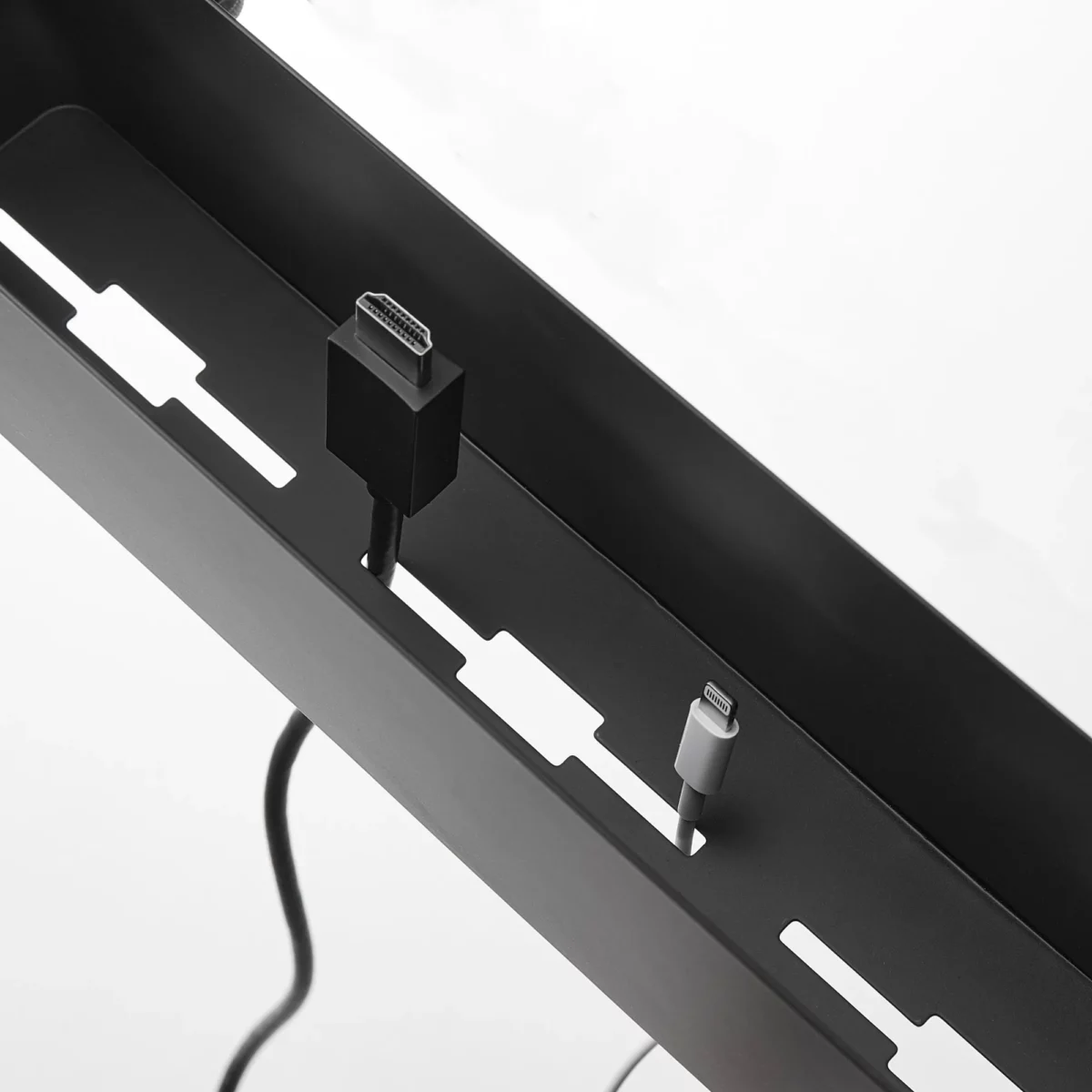 Yamazaki TOWER Narrow Table Clamp Basket in Black, with cable slots on the bottom and a cable threaded through