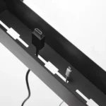 Yamazaki TOWER Narrow Table Clamp Basket in Black, with cable slots on the bottom and a cable threaded through