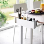 Yamazaki TOWER Narrow Table-Clamp Basket in White, clamped to the dining table with cutlery and spices