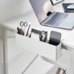 Yamazaki TOWER Narrow Table Clamp Basket in White, on a desk with scissors, a notepad, and a smartphone