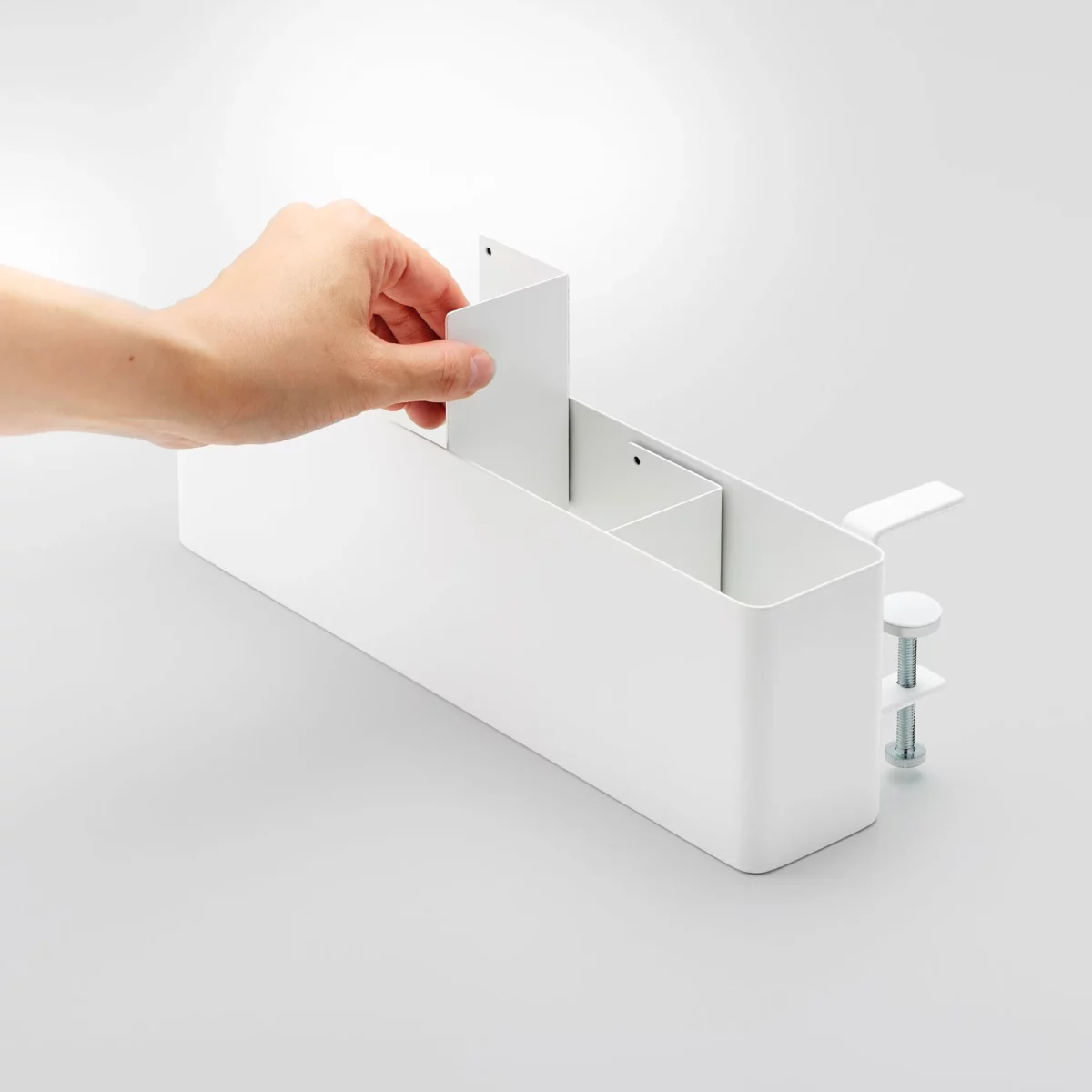 Yamazaki TOWER Narrow Table Clamp Basket in White; the user inserts one of the two dividers
