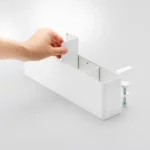 Yamazaki TOWER Narrow Table Clamp Basket in White; the user inserts one of the two dividers