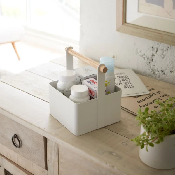 Yamazaki TOSCA Small Utensil Box in White, used as a first-aid kit on the wooden dresser