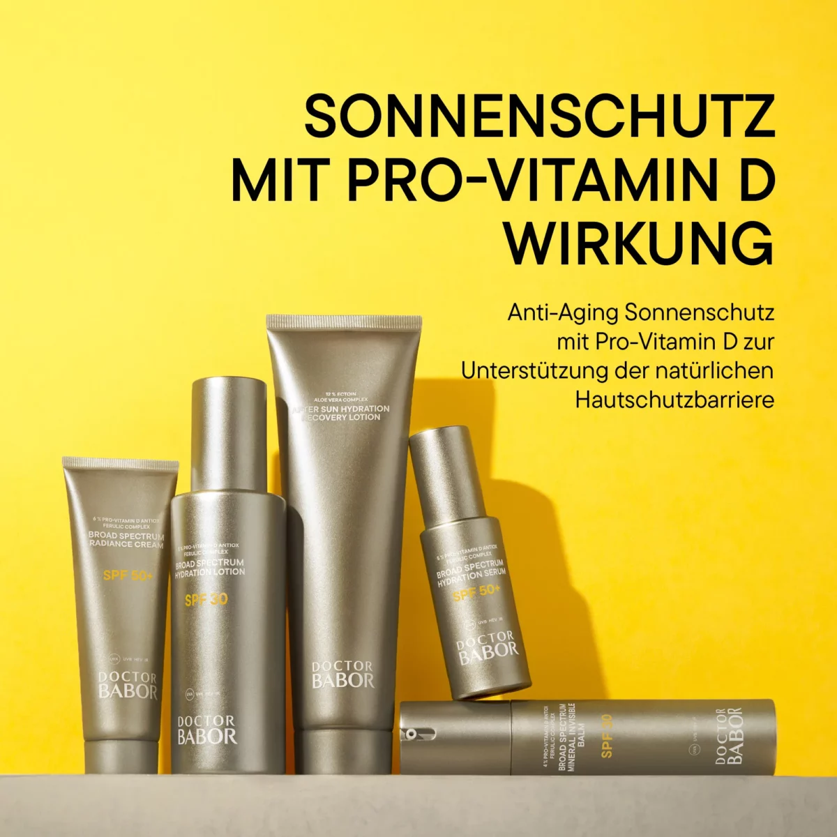 Produkte der Linie DOCTOR BABOR Solar Defense vor gelbem Hintergrund, Kampagnenbild Sonnenschutz mit Pro-Vitamin D