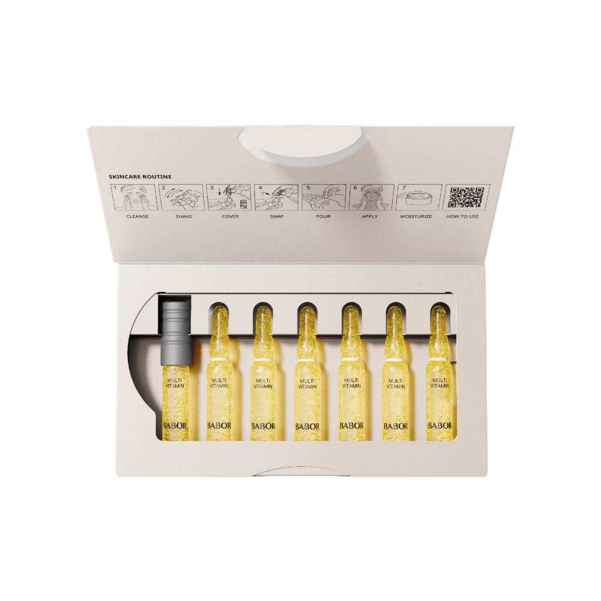 Geöffnete Packung BABOR Multi Vitamin mit den Ampullen in einer Reihe, dem Ampullenöffner und der Anleitung im Deckel