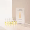 Mehrere BABOR Multi Vitamin Ampullen stehend im warmen Licht auf heller Fläche, Lifestyle-Foto