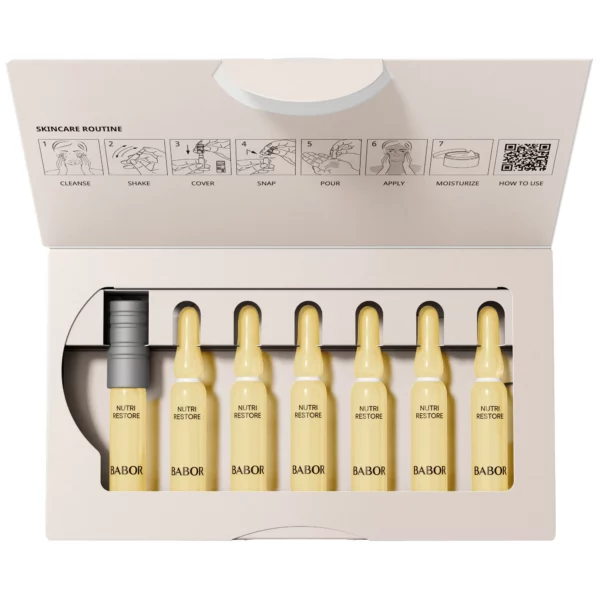 Geöffnete Packung BABOR Nutri Restore mit sieben gelben Ampullen, Ampullenöffner und Anleitung im Deckel