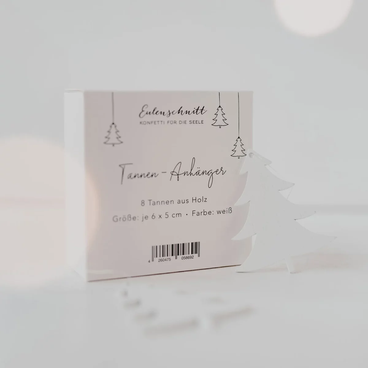Packaging for the Eulenschnitt wooden fir tree pendants (set of 8) in white, with dimensions listed as 6 x 5 cm and a white fir tree next to it