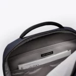 Inside the main compartment of the Ucon Acrobatics Hajo Pro backpack in dark navy with laptop sleeve and brand label