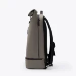 Left side view of the Ucon Acrobatics Hajo Pro backpack in dark grey with rolled top and separate bottom compartment