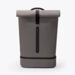 Front view of the Ucon Acrobatics Hajo Pro roll-top backpack in dark grey with the vertical zip of the front pocket