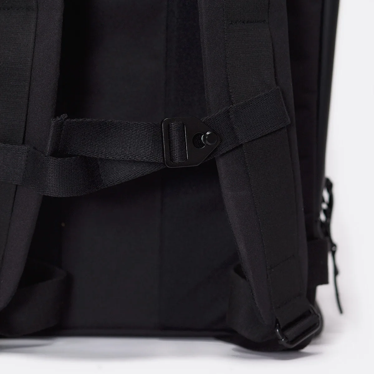Close-up of the adjustable chest strap and buckle on the Ucon Acrobatics Hajo Pro backpack in black