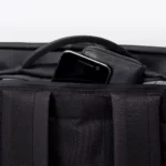 Pocket at the top of the back panel of the Ucon Acrobatics Hajo Pro backpack in black holding a phone and wallet